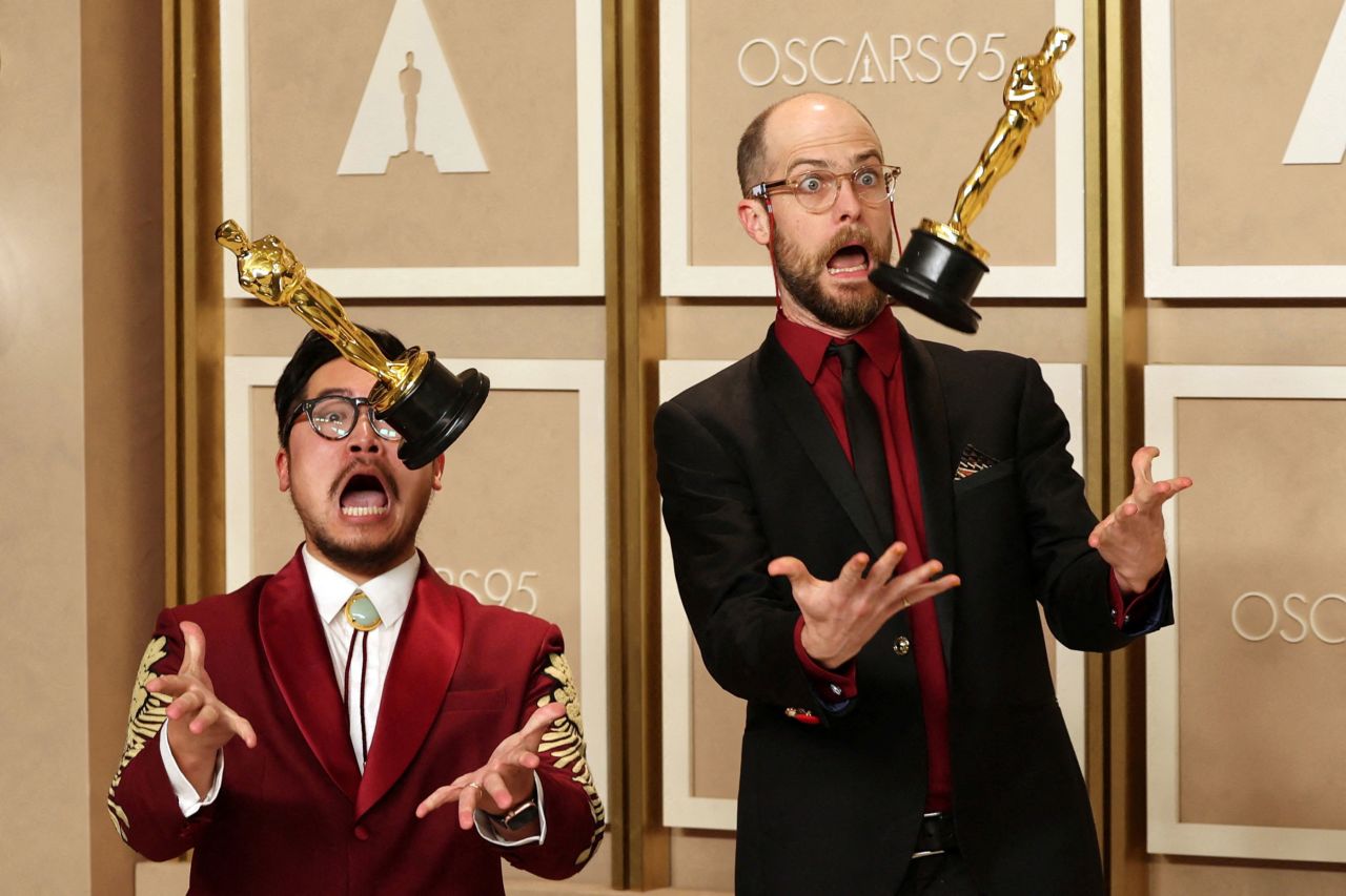 "Everything Everywhere All at Once" directors Daniel Kwan, left, and Daniel Scheinert have fun with their <a href="https://www.cnn.com/interactive/2023/03/entertainment/oscar-statuette-design-cnnphotos/index.html" target="_blank">Oscar statuettes</a> as they meet with the press at the <a href="https://www.cnn.com/2023/03/12/entertainment/gallery/2023-academy-awards-ceremony/index.html" target="_blank">Academy Awards</a> in Los Angeles, on Sunday, March 12. Their film won seven Oscars, including best picture and best director.   