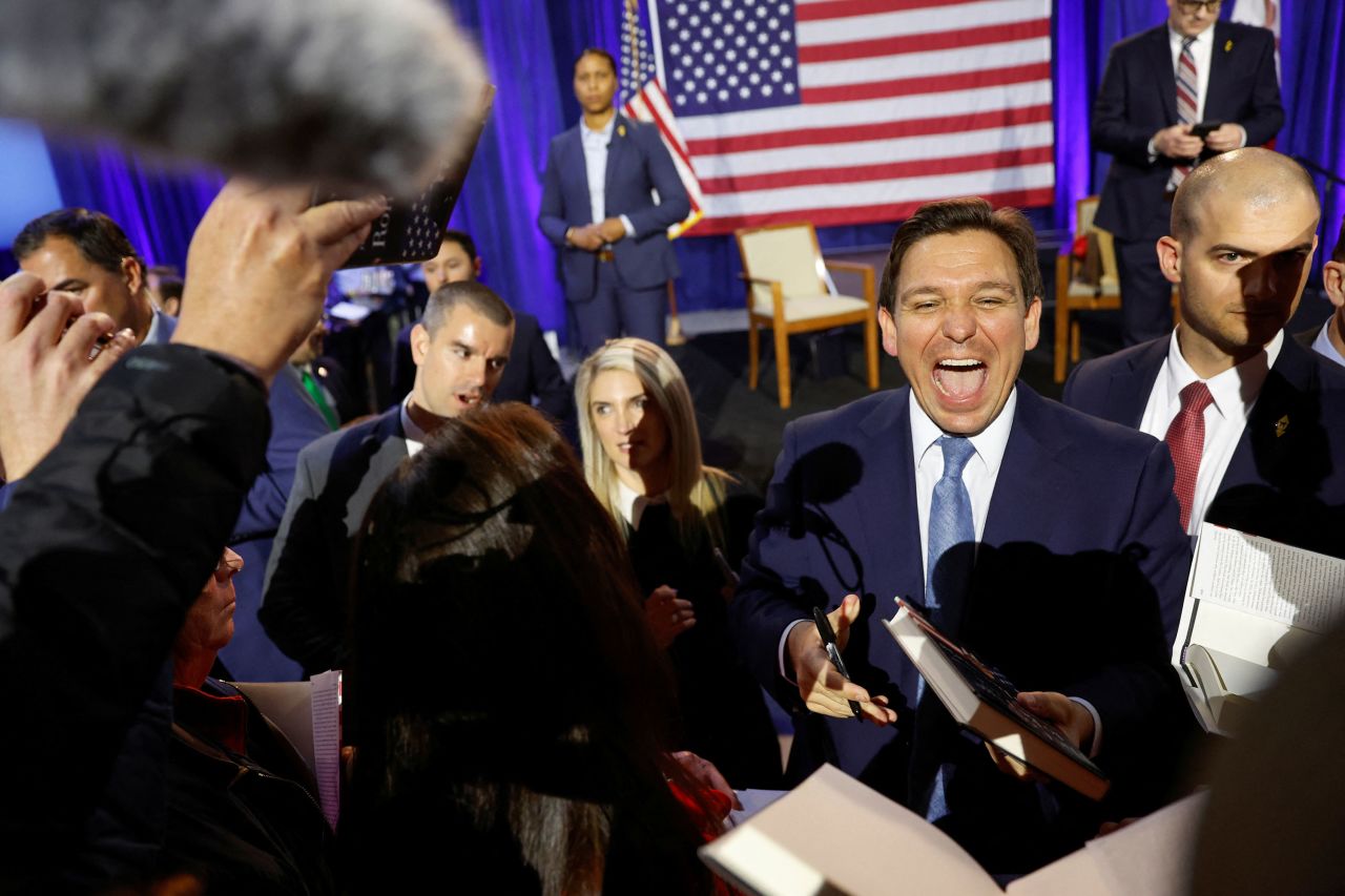 Florida Gov. Ron DeSantis greets attendees and signs copies of his book during a book tour stop at the Iowa State Fairgrounds in Des Moines on Friday, March 10.