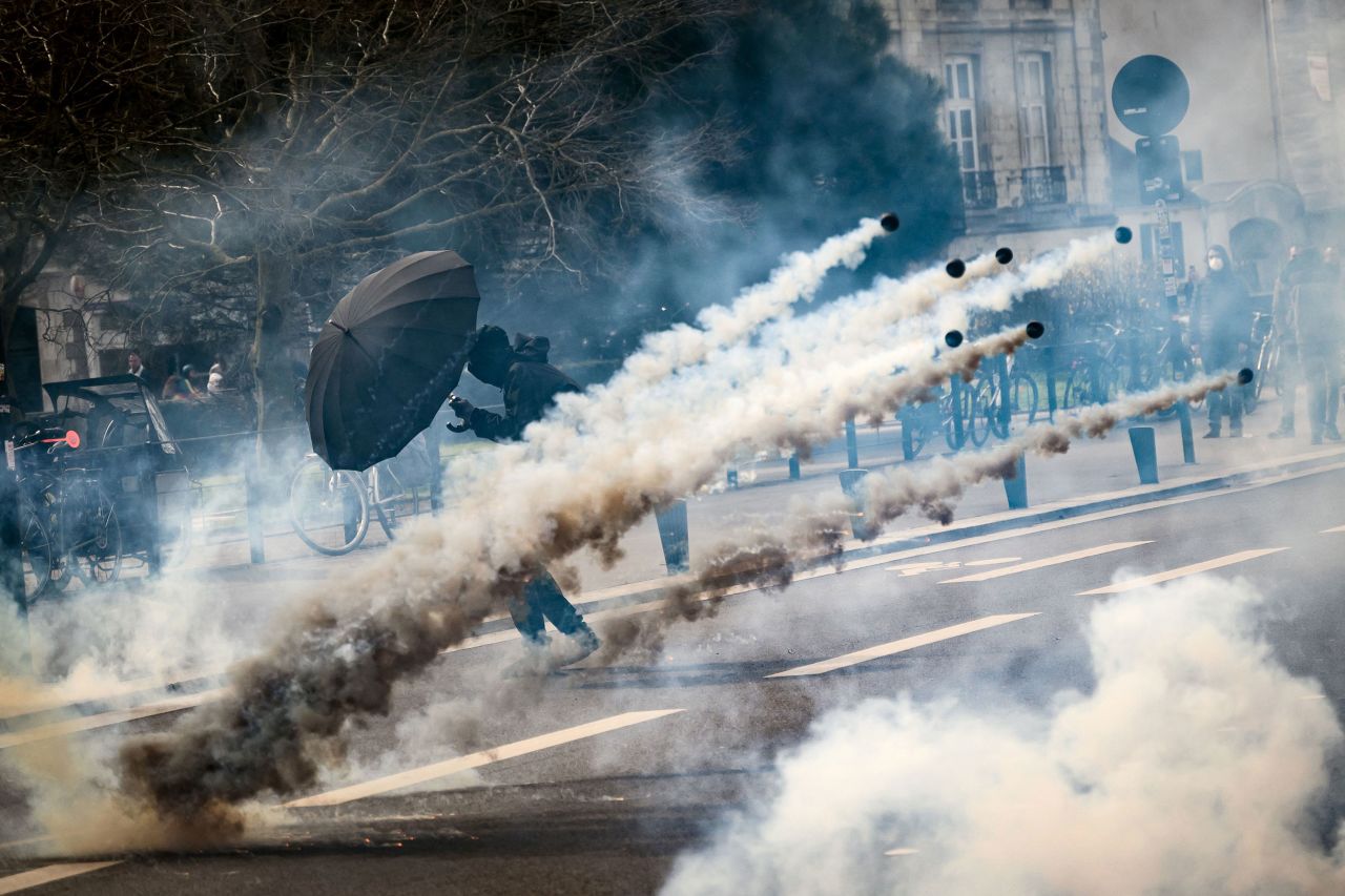 A demonstrator holds an umbrella to protect themselves from tear gas during a protest in Nantes, France, on Wednesday, March 15. Protesters have been taking action against the government's <a href="https://www.cnn.com/2023/03/16/europe/france-pension-reform-strikes-intl/index.html" target="_blank">proposed pension reforms</a>.
