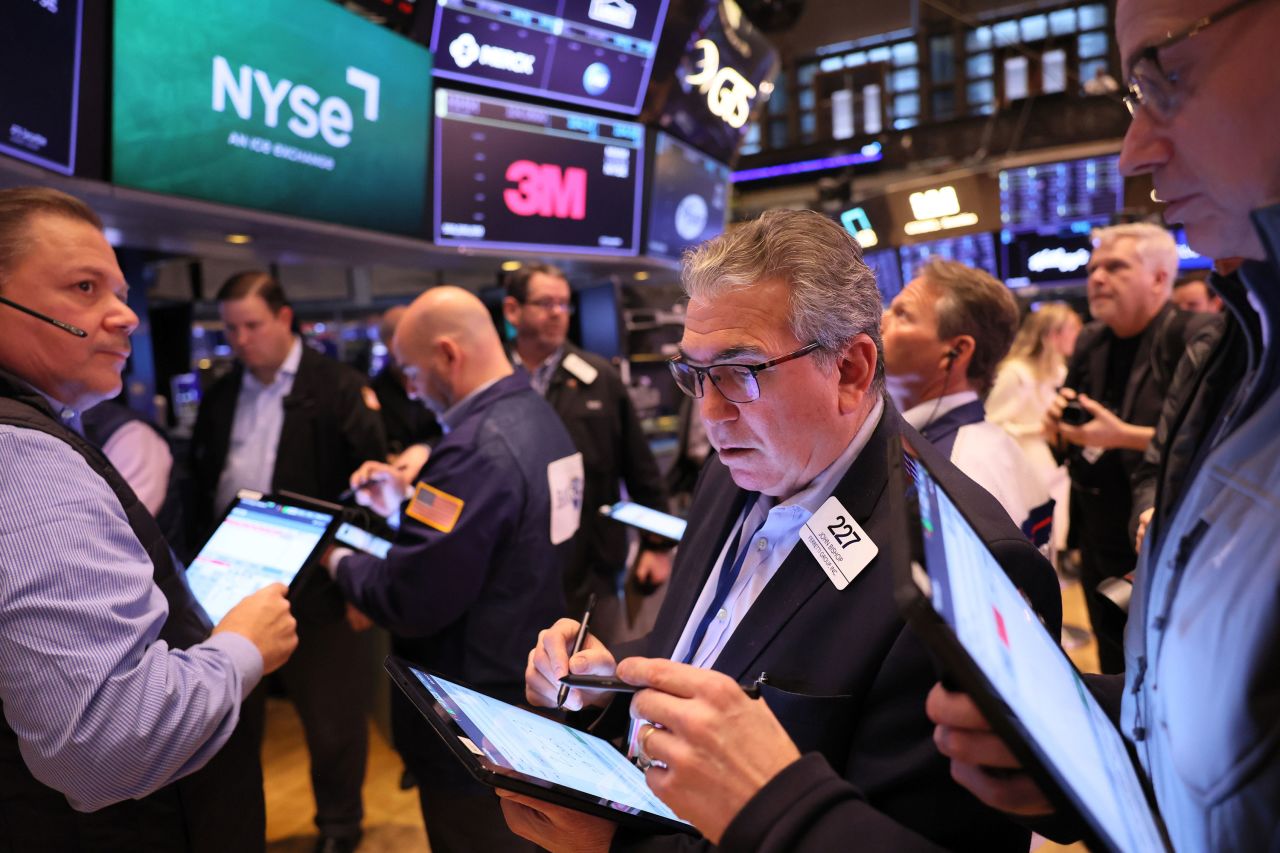 Traders work on the floor of the New York Stock Exchange on Monday, March 13. Stocks continued their downward trend following news of <a href=