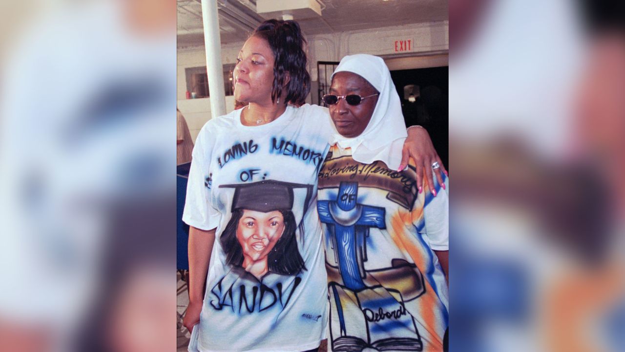 Tracey Lomax, left, and Carolyn Johnson wear custom shirts in memory of their slain sisters at a news conference following the execution of Gary Heidnik in 1999.