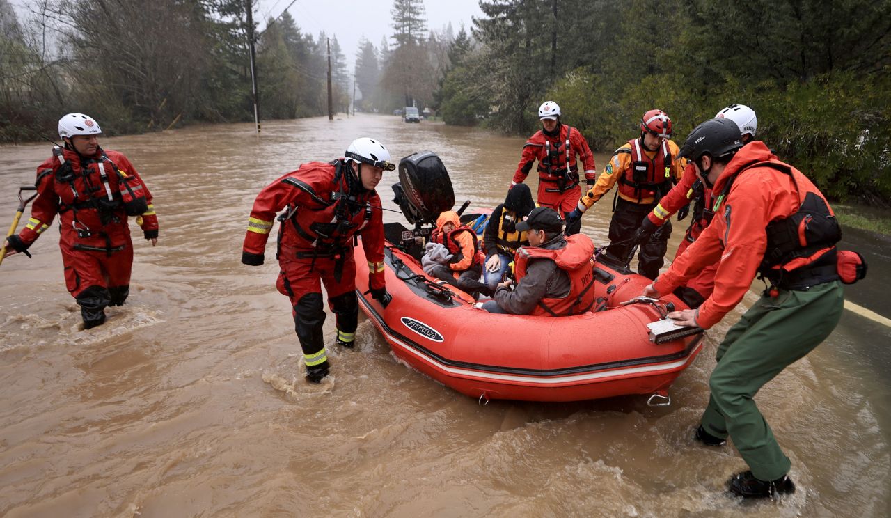 Emergency workers rescue people from floodwaters in Guerneville, California, on Tuesday, March 14.