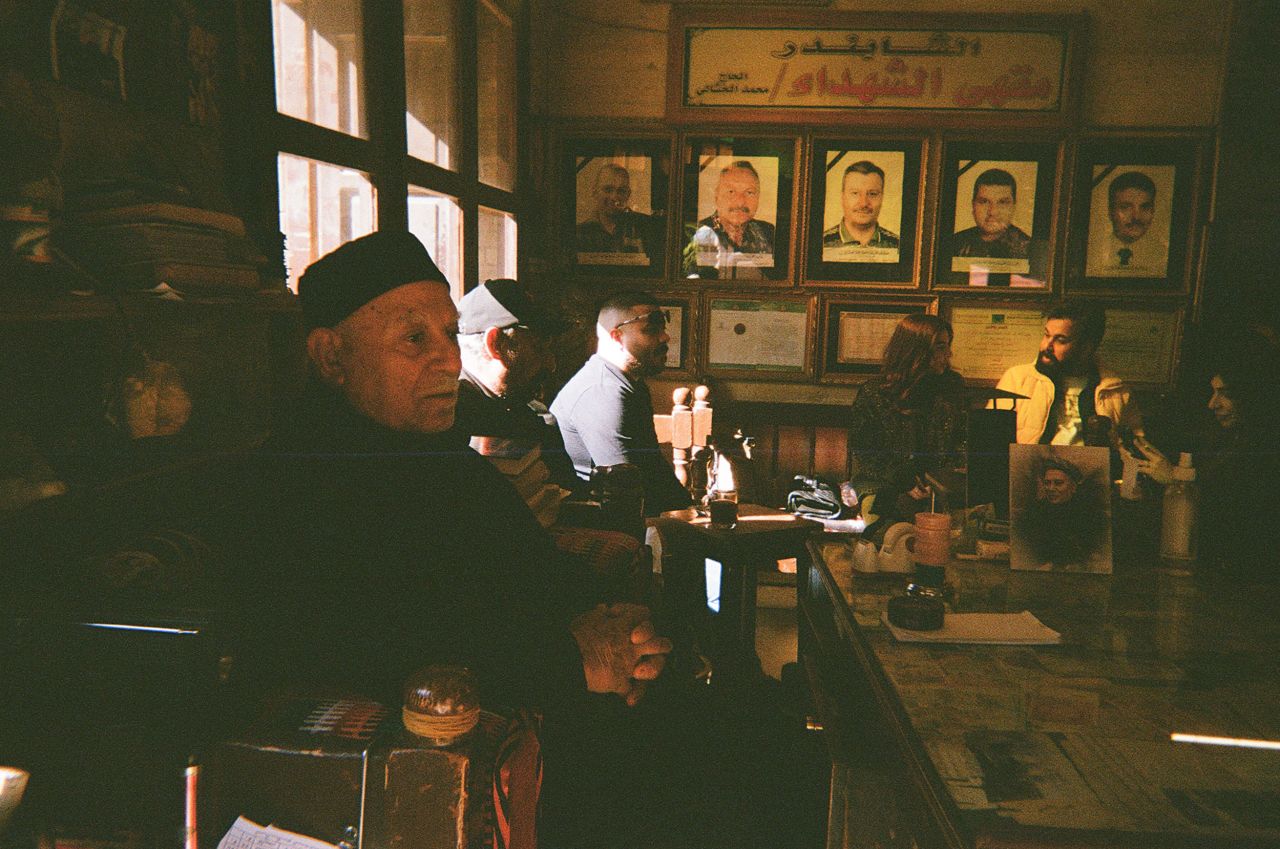 Mohammed Al-Khashali is the owner of the century-old Shabandar Café in Baghdad. A terrorist explosion in 2007 on the cafe's street killed five of his children. Their faces are shown in pictures hanging on the wall.