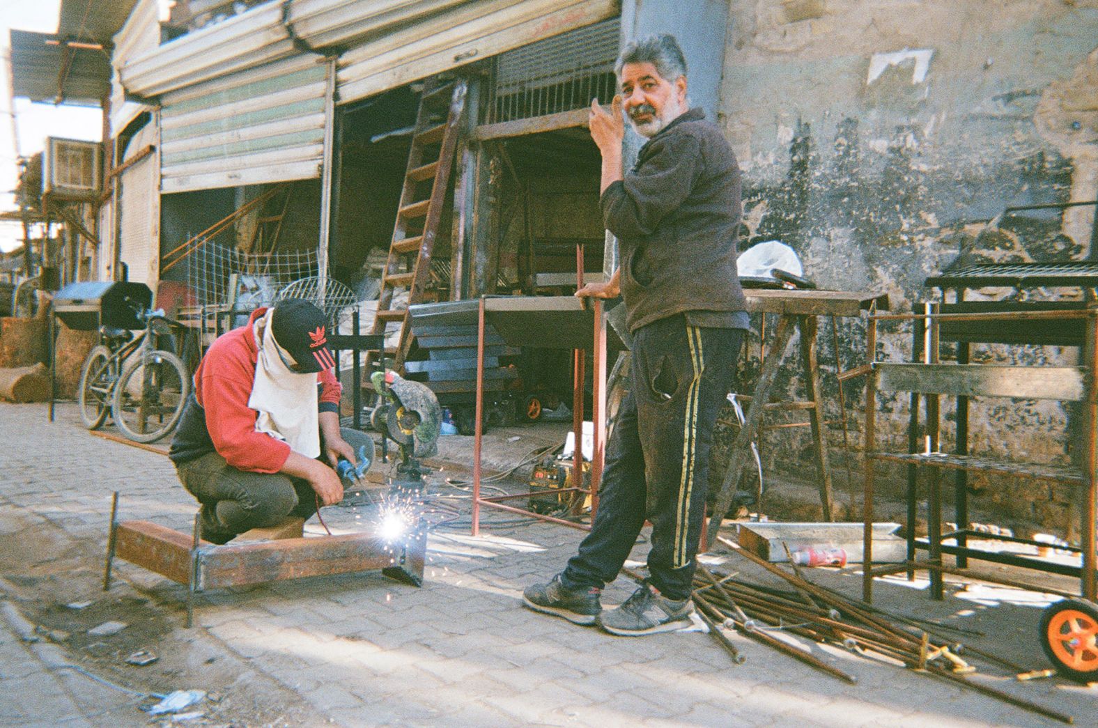 Zaid Kamel Abu Ali, 59, (right) looks up from his work as a blacksmith in Baghdad. "I have been working as a barbecue maker for 12 years," he told Raheem. "I enjoy my work a lot, sometimes I work even on weekends."
