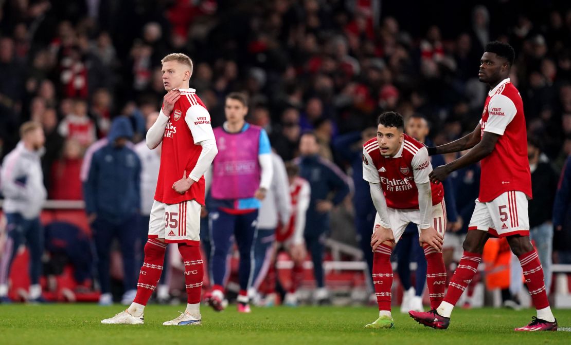 Arsenal's Oleksandr Zinchenko (left), Gabriel Martinelli (centre) and Thomas Partey look dejected after losing against Sporting CP.
