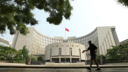 BEIJING, CHINA - JULY 20: A man walks past the People's Bank of China (PBOC) building on July 20, 2022 in Beijing, China. (Photo by Jiang Qiming/China News Service via Getty Images)