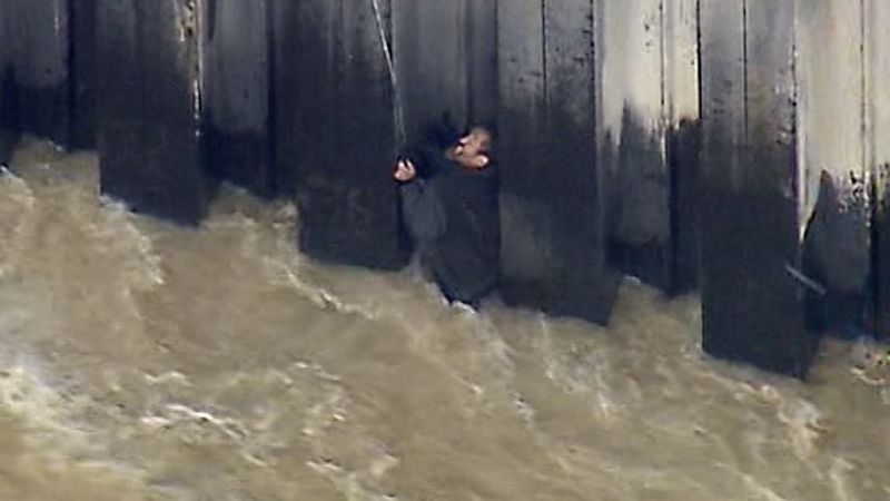 Los Angeles man stranded in river flooding rescued by firefighter helicopter | CNN