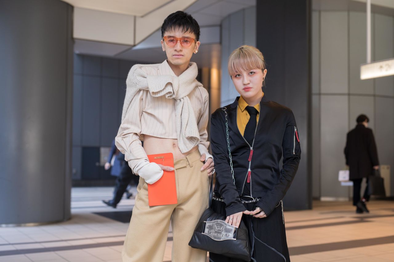 Two guests attending a show on Tuesday complement one another in cream and black ensembles.