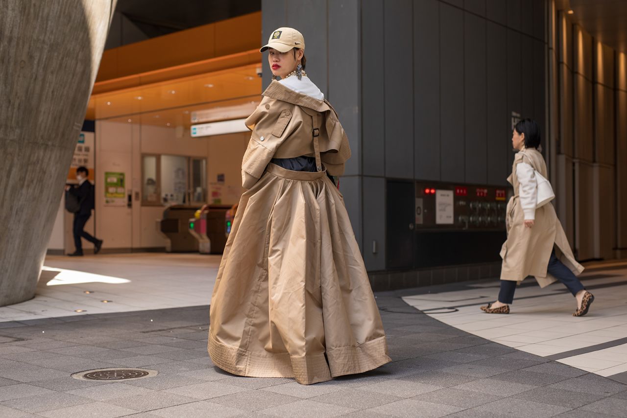A guest is seen wearing trenchcoat and pearls attending the Pillings show on Thursday.