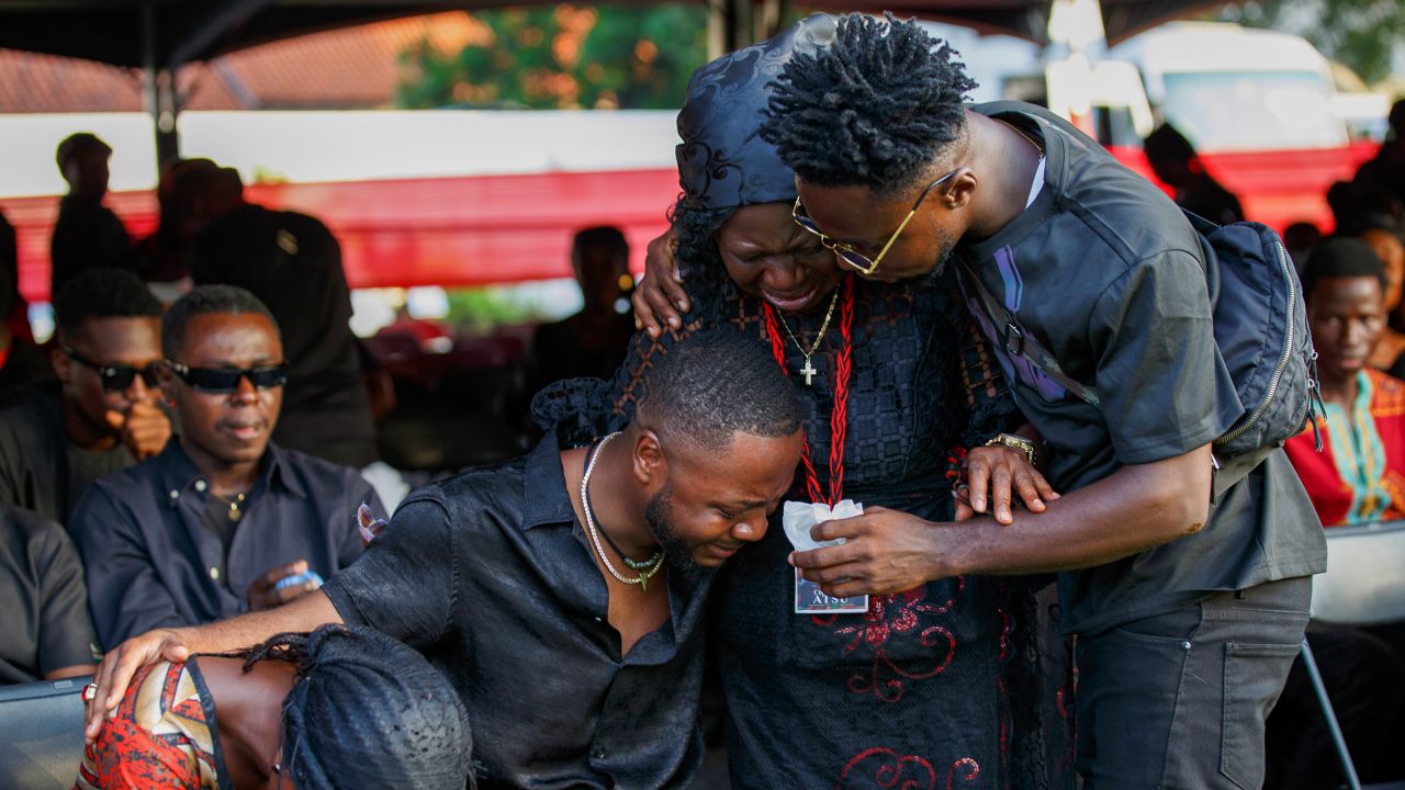 Relatives of Atsu are overcome with emotion during his funeral at the State House in Accra.
