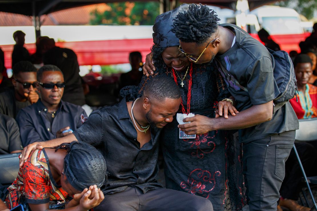 Relatives of Atsu are overcome with emotion during his funeral at the State House in Accra.
