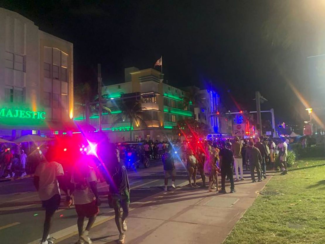 Police and pedestrians are seen walking along Ocean Drive in South Beach on March 17, 2023, in Miami. 