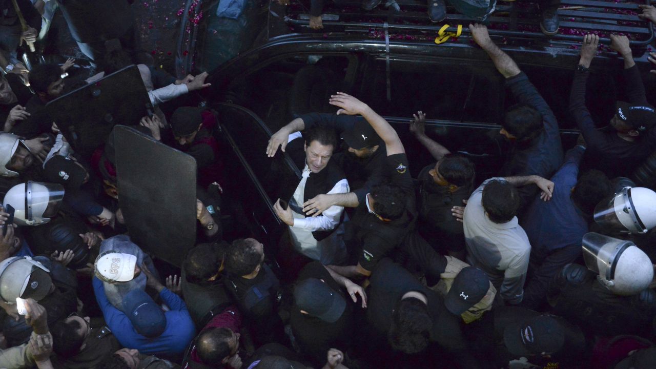 Security personnel make way for former Prime Minister Imran Khan as he arrives to appear in court, in Lahore, Pakistan, on Friday March 17, 2023.
