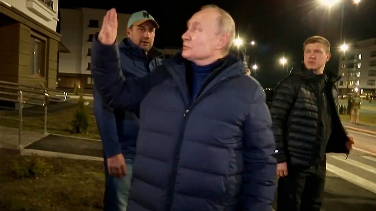 Putin waves local residents after visiting their new flat during his visit to Mariupol in Russian-controlled Donetsk region, Ukraine.
