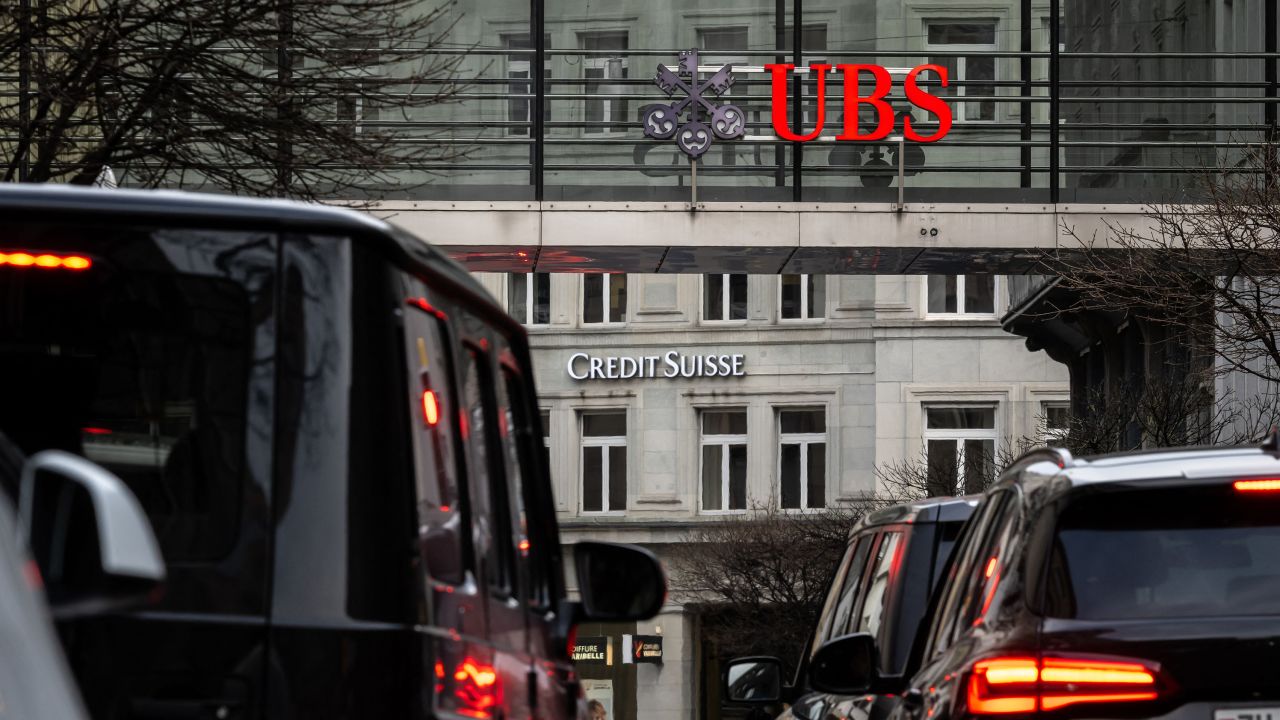A sign of Credit Suisse pictured behind a sign of UBS in Zurich on March 18, 2023.