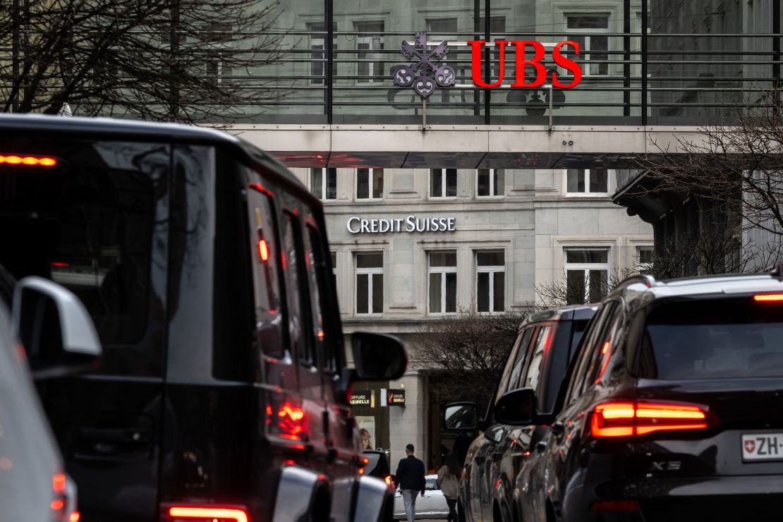 A sign of Credit Suisse pictured behind a sign of UBS in Zurich on March 18, 2023.