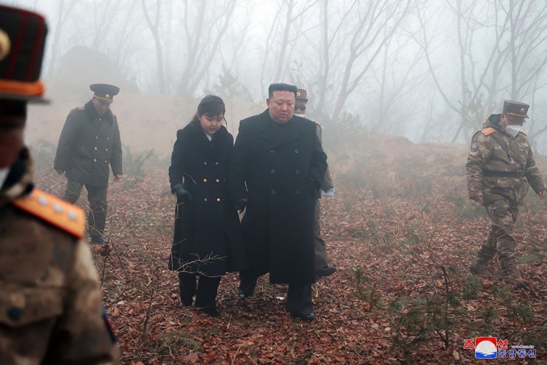 North Korean leader Kim Jong Un walks with his daughter during military drills on March 19, 2023.
