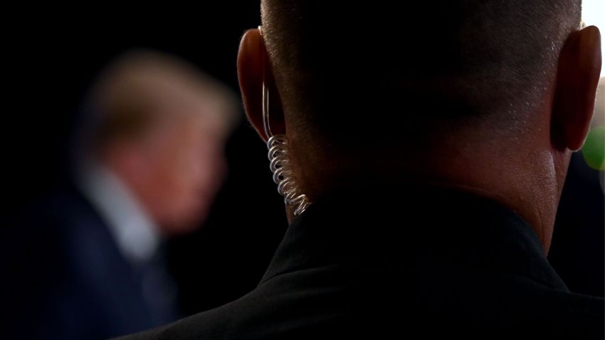 A secret service agent watches as US President Donald Trump speaks during a news conference in Bedminster, New Jersey, on August 7, 2020. (Photo by JIM WATSON / AFP) (Photo by JIM WATSON/AFP via Getty Images)