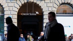 People walk near the logo of the Swiss bank Credit Suisse in Zurich, Switzerland March 20, 2023. REUTERS/Denis Balibouse