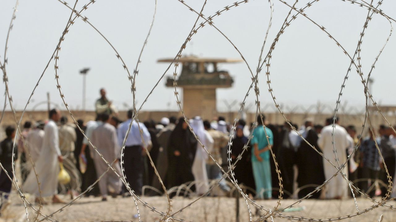 Iraqis line up outside Abu Ghraib prison near Baghdad, while they wait to get information about their relatives held inside, on May 16, 2004.