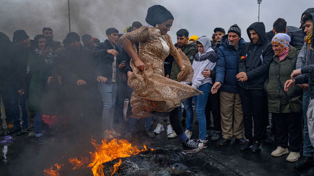 A woman jumps over a bonfire during a Kurdish celebration of Nowruz, the new year of the Persian calendar, in Istanbul on Sunday.  