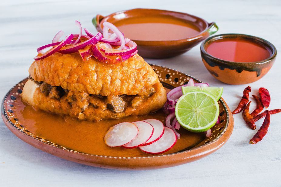 <strong>Torta ahogada: </strong>This is the "drowned" version of the torta popular in Guadalajara. Featuring marinated fried pork, this sandwich is submerged in a tomato and vinegar-based bath seasoned with spices.