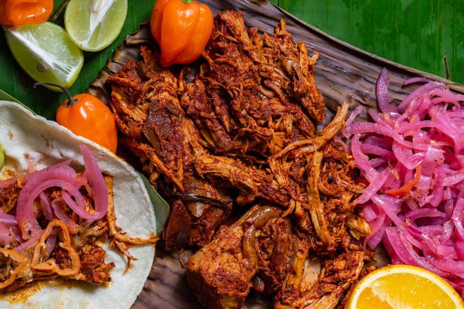 <strong>Cochinita pibil:</strong> This dish involves a suckling pig marinated with bitter orange juice seasoned with achiote seed and spices and then wrapped in a banana leaf to be slow-roasted for hours. 