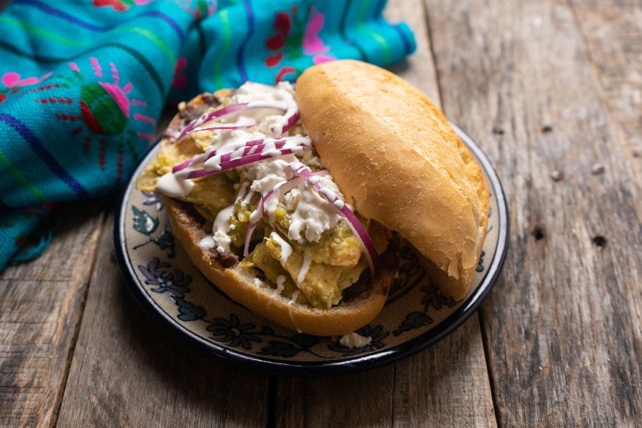 <strong>Tecolota: </strong>This dish takes the traditional chilaquiles dish up another level. The tecolota involves a toasty <em>bolillo </em>roll, filled with refried beans, chilaquiles, along with cheese, crema, cilantro and red onions.