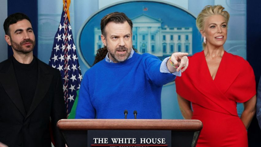 Jason Sudeikis is flanked by fellow Ted Lasso cast members Brett Goldstein and Hannah Waddingham as he takes questions at the daily press briefing in the Brady Press Briefing Room at the White House in Washington, U.S., March 20, 2023. REUTERS/Kevin Lamarque