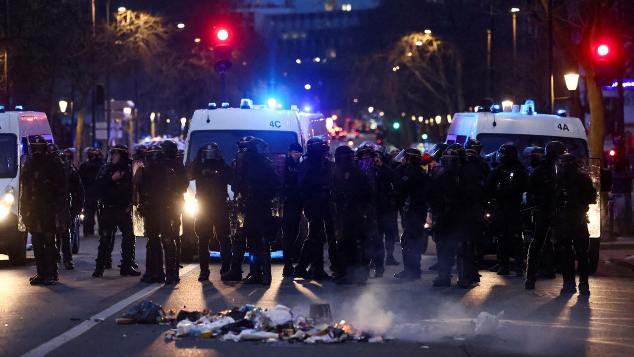 French CRS riot police officers stand guard during a demonstration in Paris on March 20, 2023. 