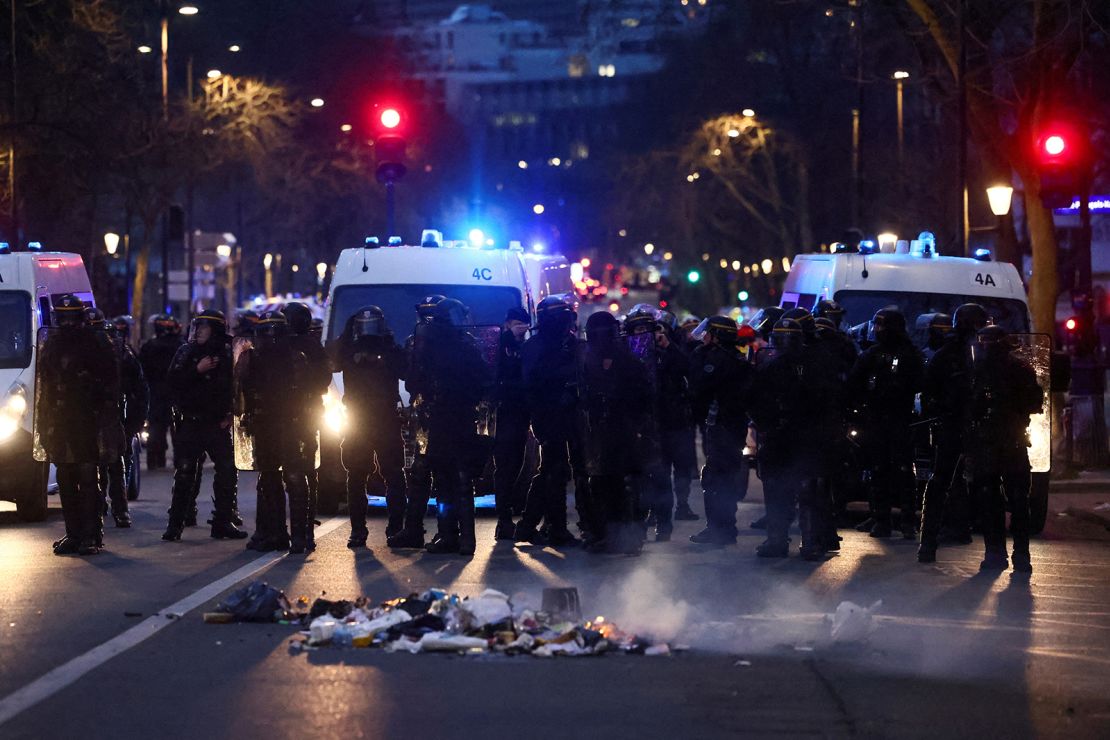 French CRS riot police officers stand guard during a demonstration in Paris on March 20, 2023. 