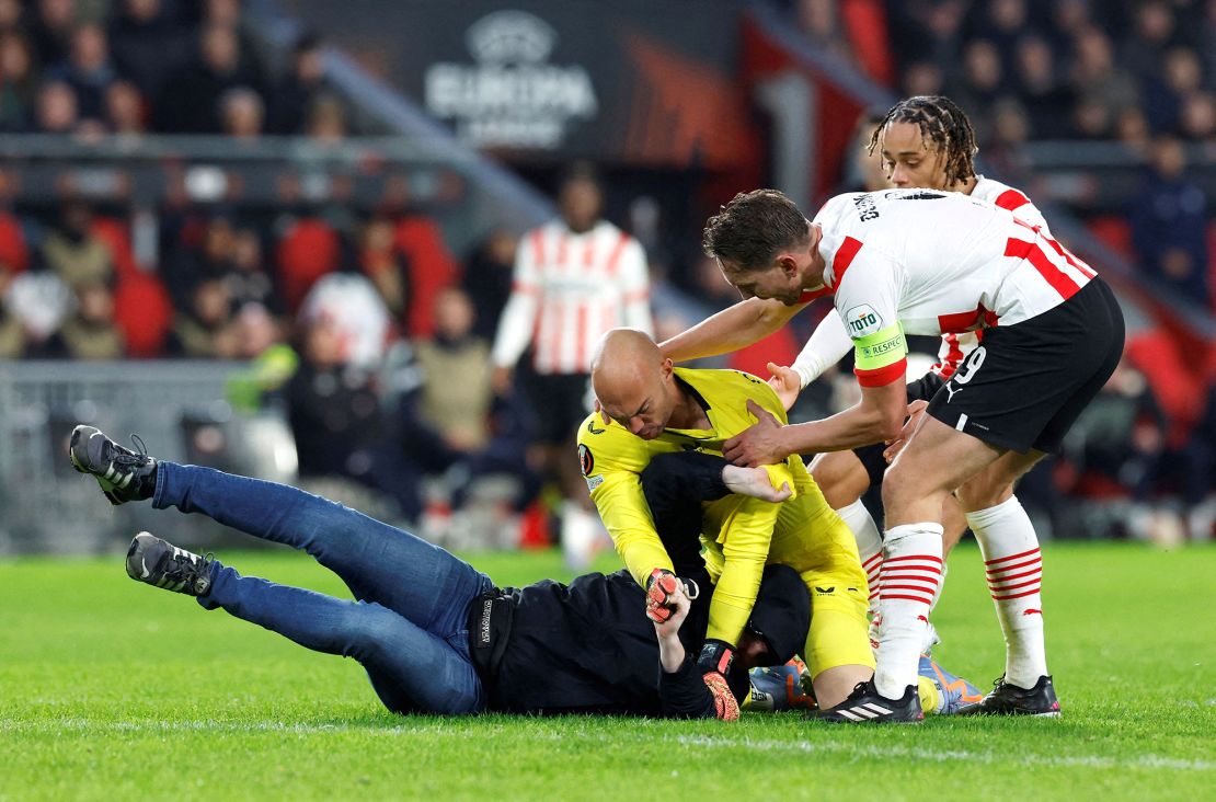 The pitch invader was promptly pinned to the ground by Dmitrović.