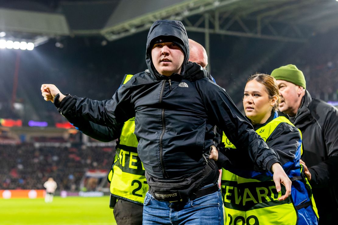 The fan was escorted from the pitch by security.