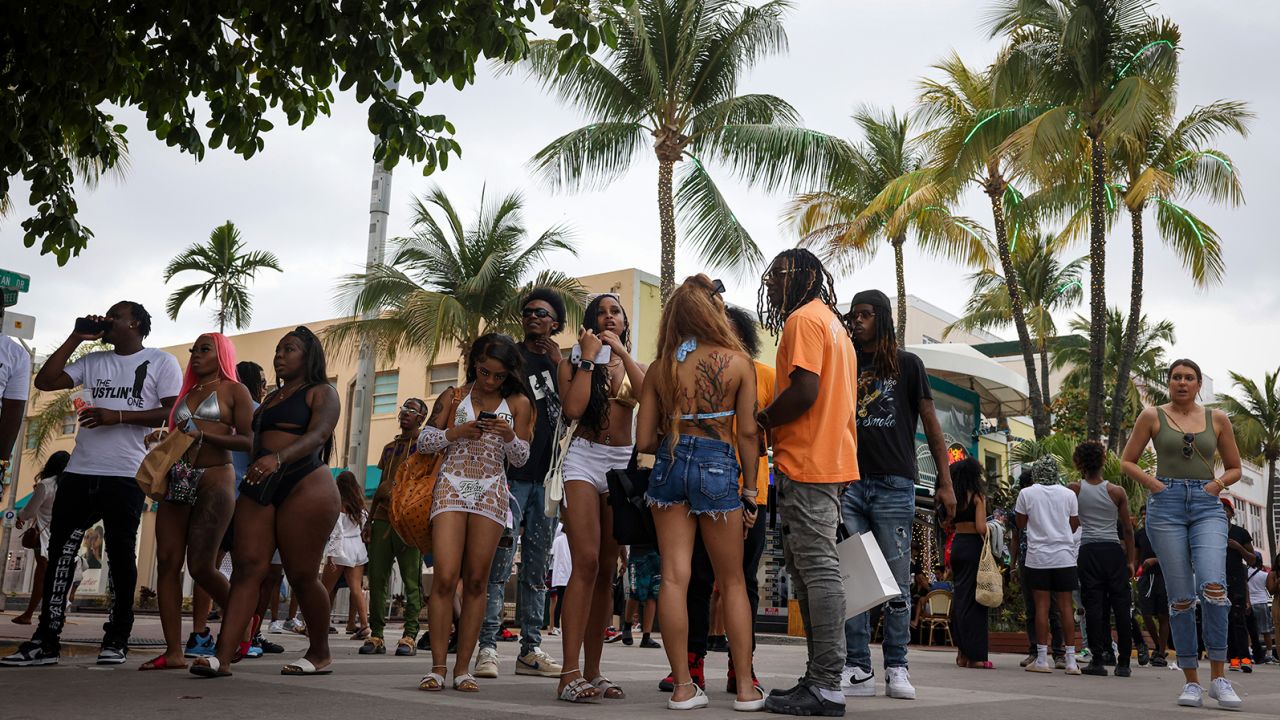 People gather outside of the Waldorf Towers Hotel   in Miami Beach hours before a curfew went into effect for one night.