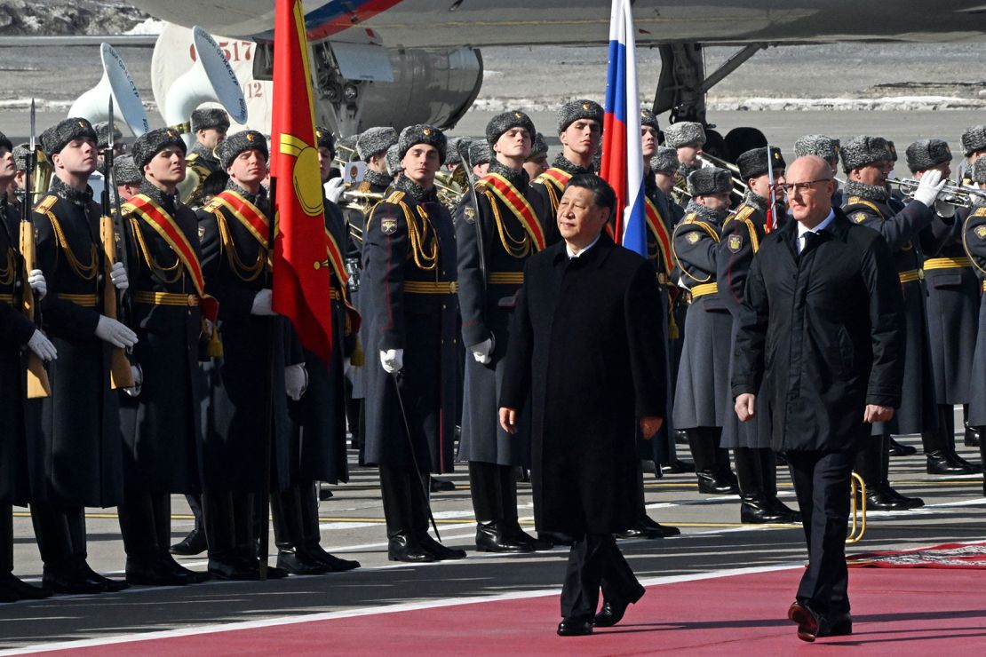 Chinese leader Xi Jinping, accompanied by Russian Deputy Prime Minister Dmitry Chernyshenko, walks past honour guards during a welcoming ceremony at Moscow's Vnukovo airport on March 20, 2023. 