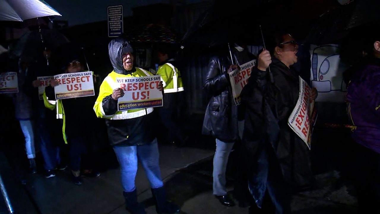 Members of Service Employees International Union Local 99 picket Tuesday at Van Nuys bus yard in Los Angeles.