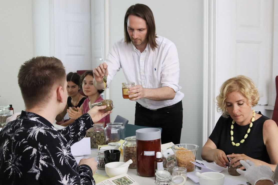 Participants in a science workshop led by Sean Coughlin in Prague experiment with interpreting ancient perfume recipes.