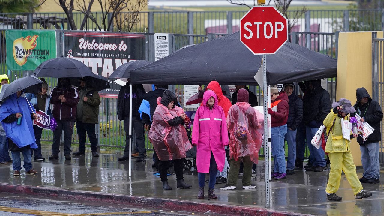 Los Angeles Unified School District teachers and Service Employees International Union 99 members strike Tuesday in heavy rain in Los Angeles.