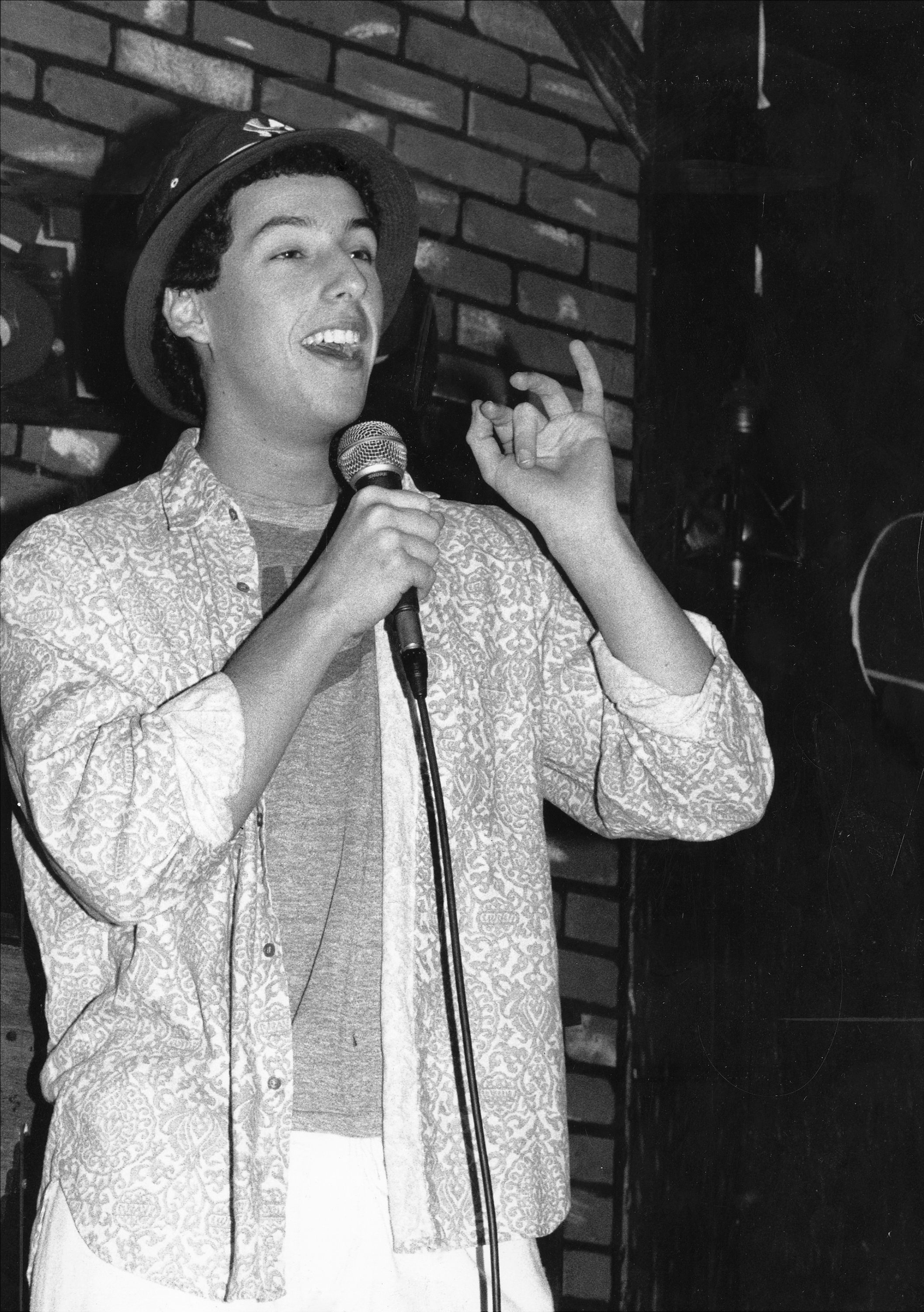 Sandler does a standup routine at the Comic Strip in New York in 1987.