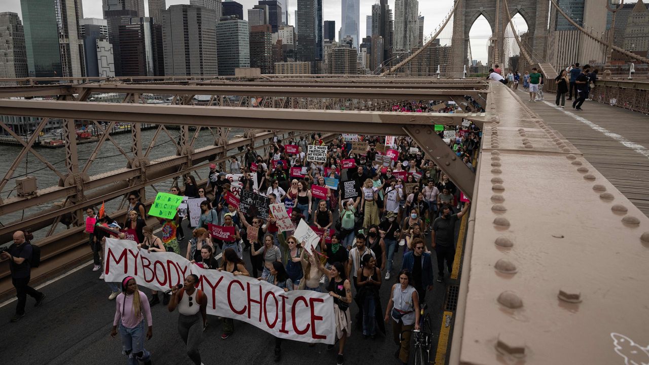 Abortion rights demonstrators walk across the Brooklyn Bridge in New York nearly two weeks after the leak of a draft Supreme Court opinion that would overturn Roe v. Wade.