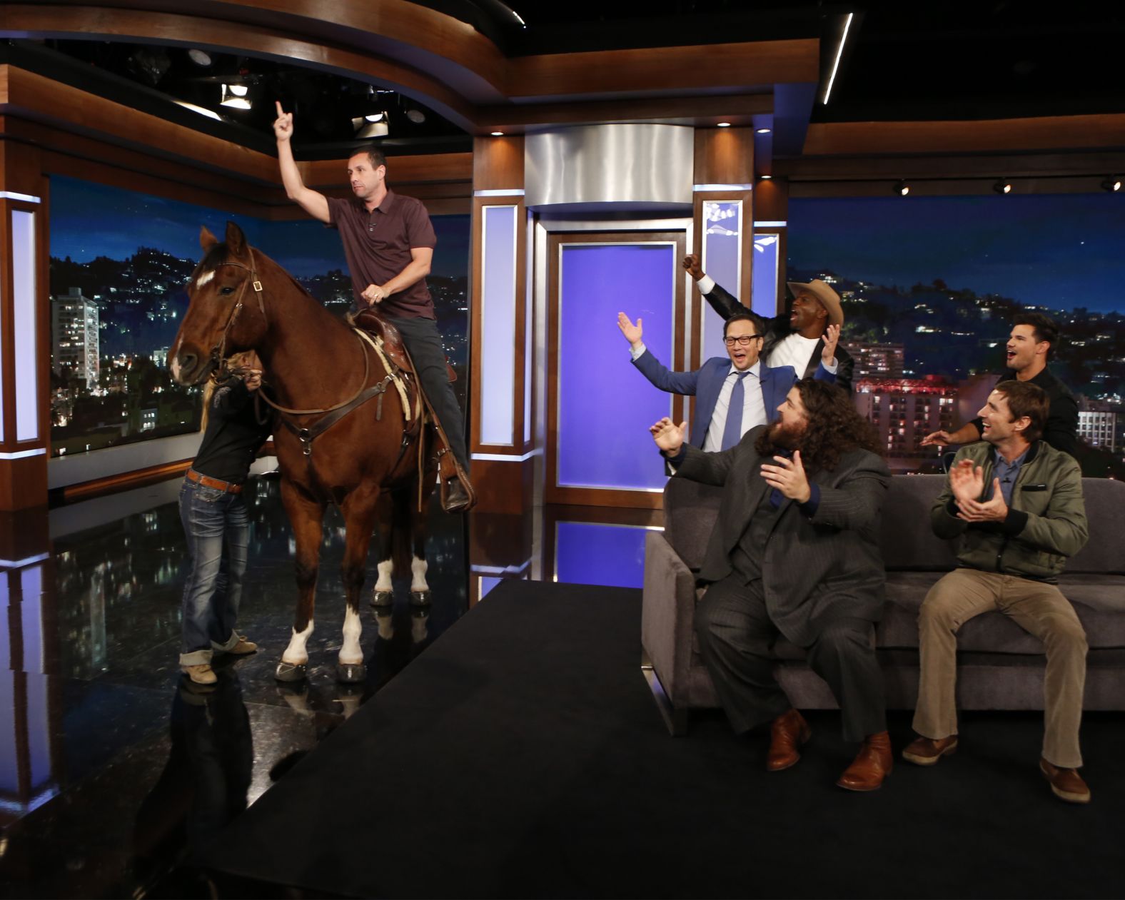 Sandler mounts a horse while appearing on "Jimmy Kimmel Live" to promote his new Western comedy, "The Ridiculous 6," in November 2015.