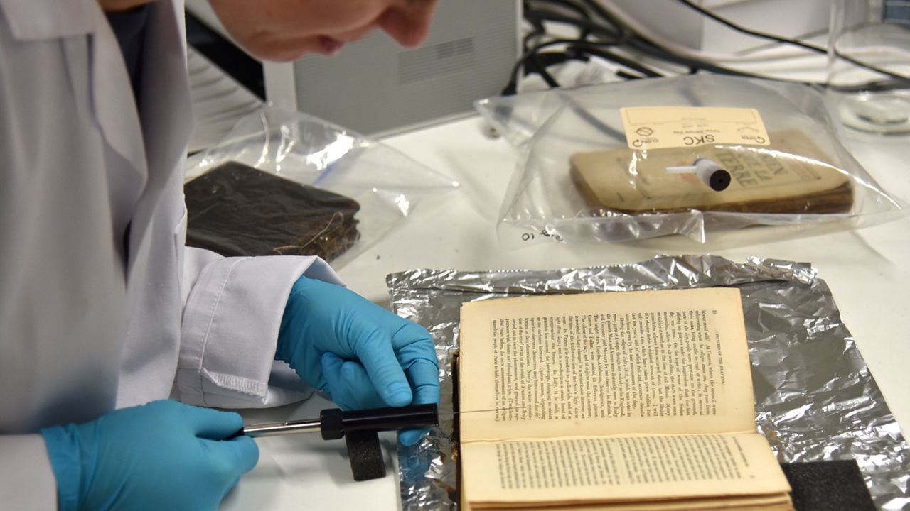 Cecilia Bembibre samples the volatile organic compounds of a historic book at the Heritage Science Lab in UCL.