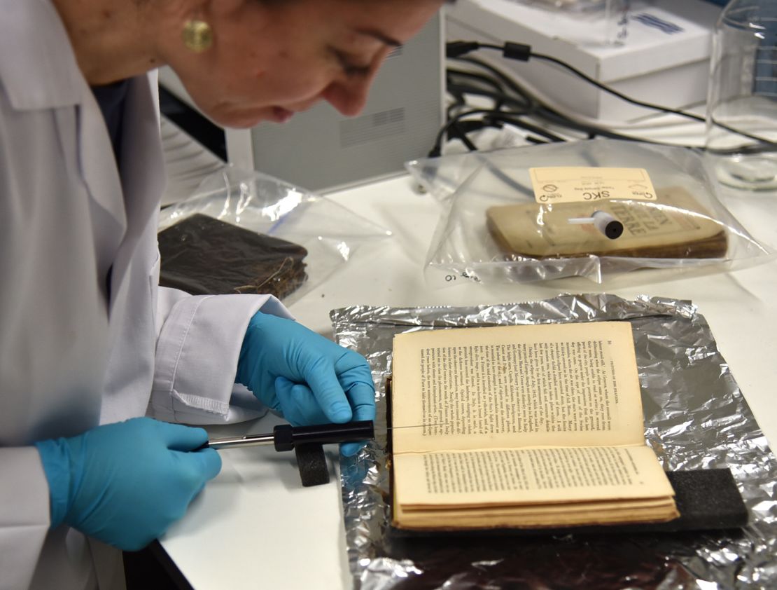 Cecilia Bembibre samples the volatile organic compounds of a historic book at the Heritage Science Lab in UCL.
