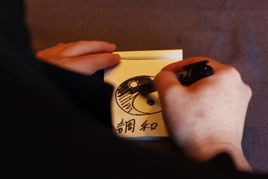 <strong>It's all about harmony:</strong> Kawada explains Sazenka's cuisine by drawing a yin-yang symbol. "It isn't fusion but harmony," he says, noting the importance of balancing the two cultures' cuisines rather than blending them.  