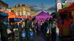 Shoppers browse stalls at Ridley Road Market in the Hackney district of London on Saturday, March 18, 2023.