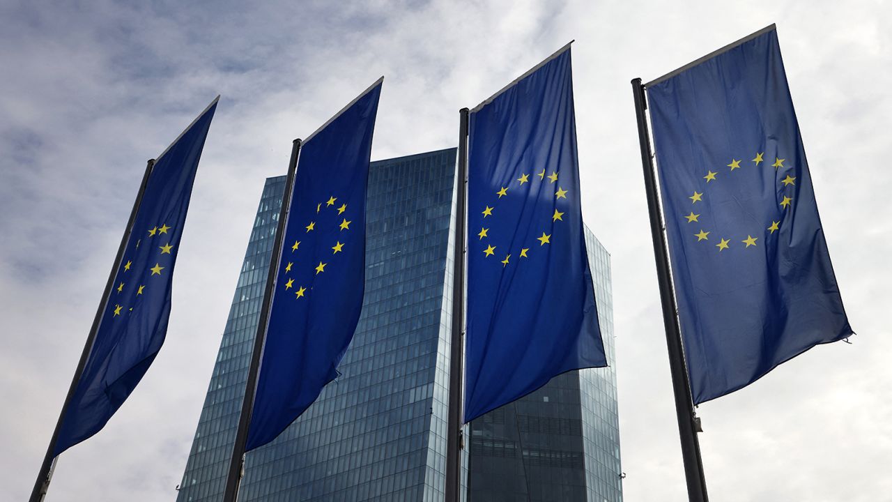 The European Central Bank (ECB) is pictured behind EU flags, prior to a press conference on the eurozone's monetary policy, in Frankfurt am Main, western Germany on March 16, 2023. 