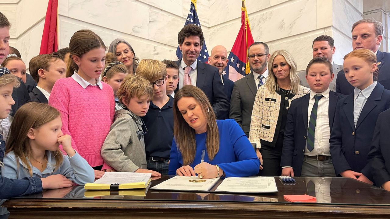In this March 8, 2023, photo, Arkansas Gov. Sarah Huckabee Sanders signs into law an education overhaul bill at the state capitol in Little Rock, Arkansas.