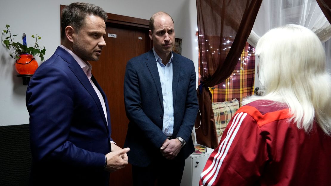 Prince William, center, and Mayor of Warsaw Rafal Trzaskowski, left, talk to an Ukrainian woman, who fled the war, during their visit to an accommodation centre in Warsaw, Poland on Wednesday evening.