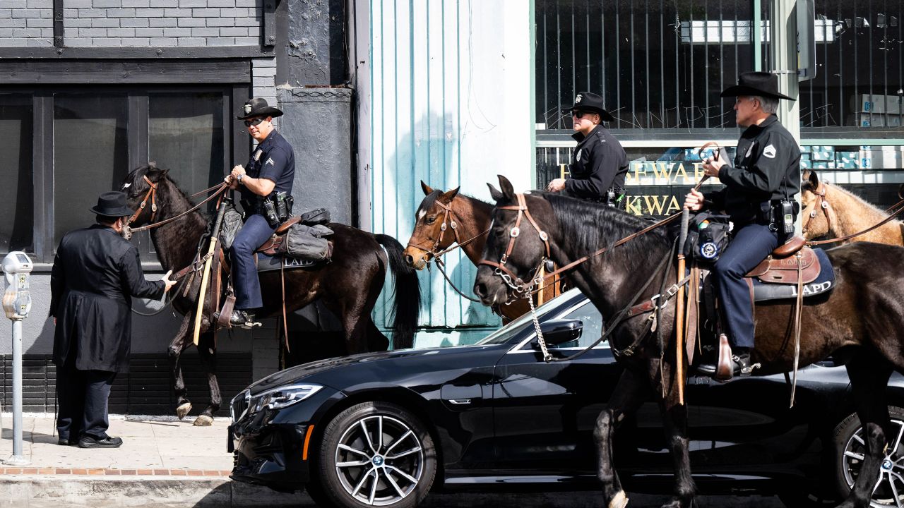 Los Angeles, CA - An LAPD Mounted Unit speaks with Rabbi Mendy Cunin as they patrol the Pico-Robertson neighborhood in Los Angeles on Friday, February 17, 2023 after the shootings of two Jewish men. (Photo by Sarah Reingewirtz/MediaNews Group/Los Angeles Daily News via Getty Images)