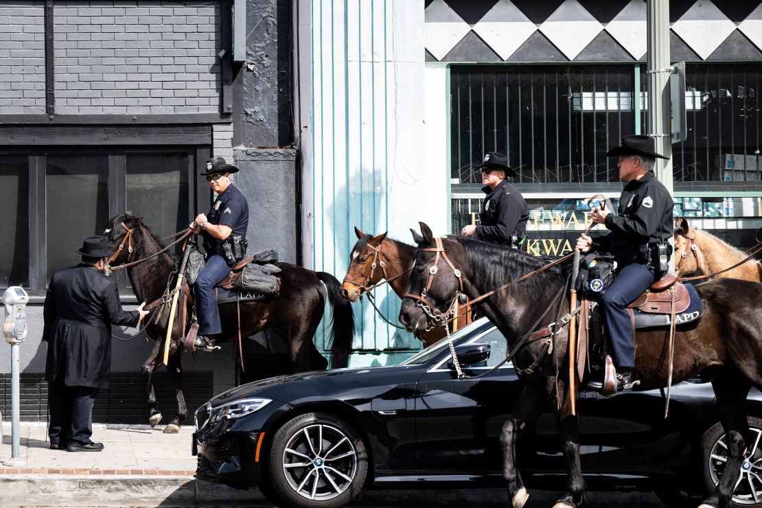 Los Angeles, CA - An LAPD Mounted Unit speaks with Rabbi Mendy Cunin as they patrol the Pico-Robertson neighborhood in Los Angeles on Friday, February 17, 2023 after the shootings of two Jewish men. (Photo by Sarah Reingewirtz/MediaNews Group/Los Angeles Daily News via Getty Images)